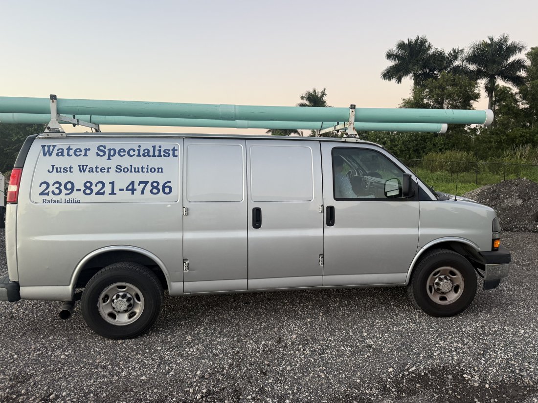 Just Water Solution silver work van with pipe on the roof rack