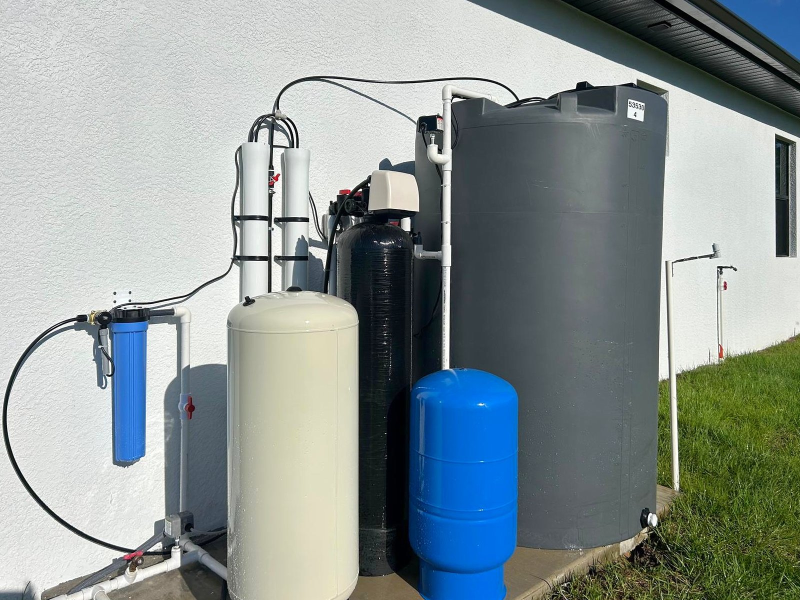 A complete whole-house system: sediment filter, membrane housings, filter tank, pressure tanks and a storage tank