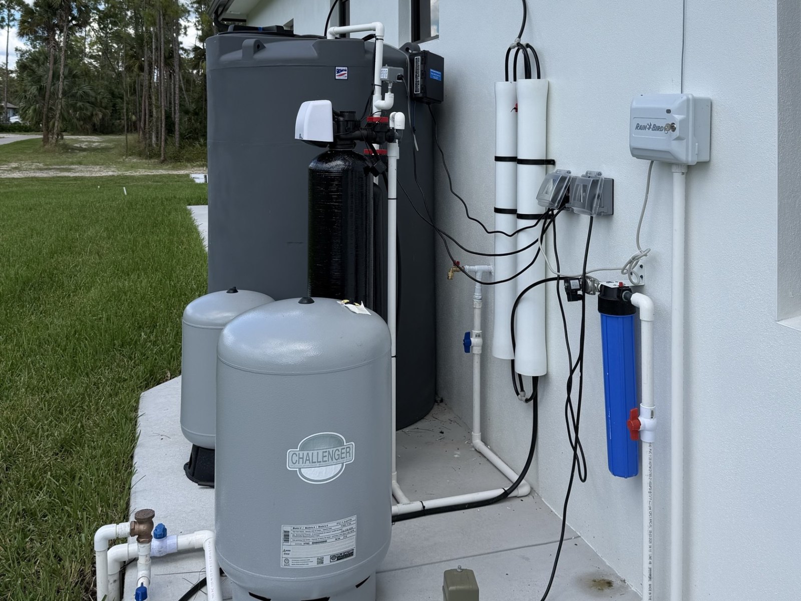 A complete whole-house reverse osmosis system: sediment filter, carbon and calcite tanks, membrane housings, pressure tanks and a storage tank