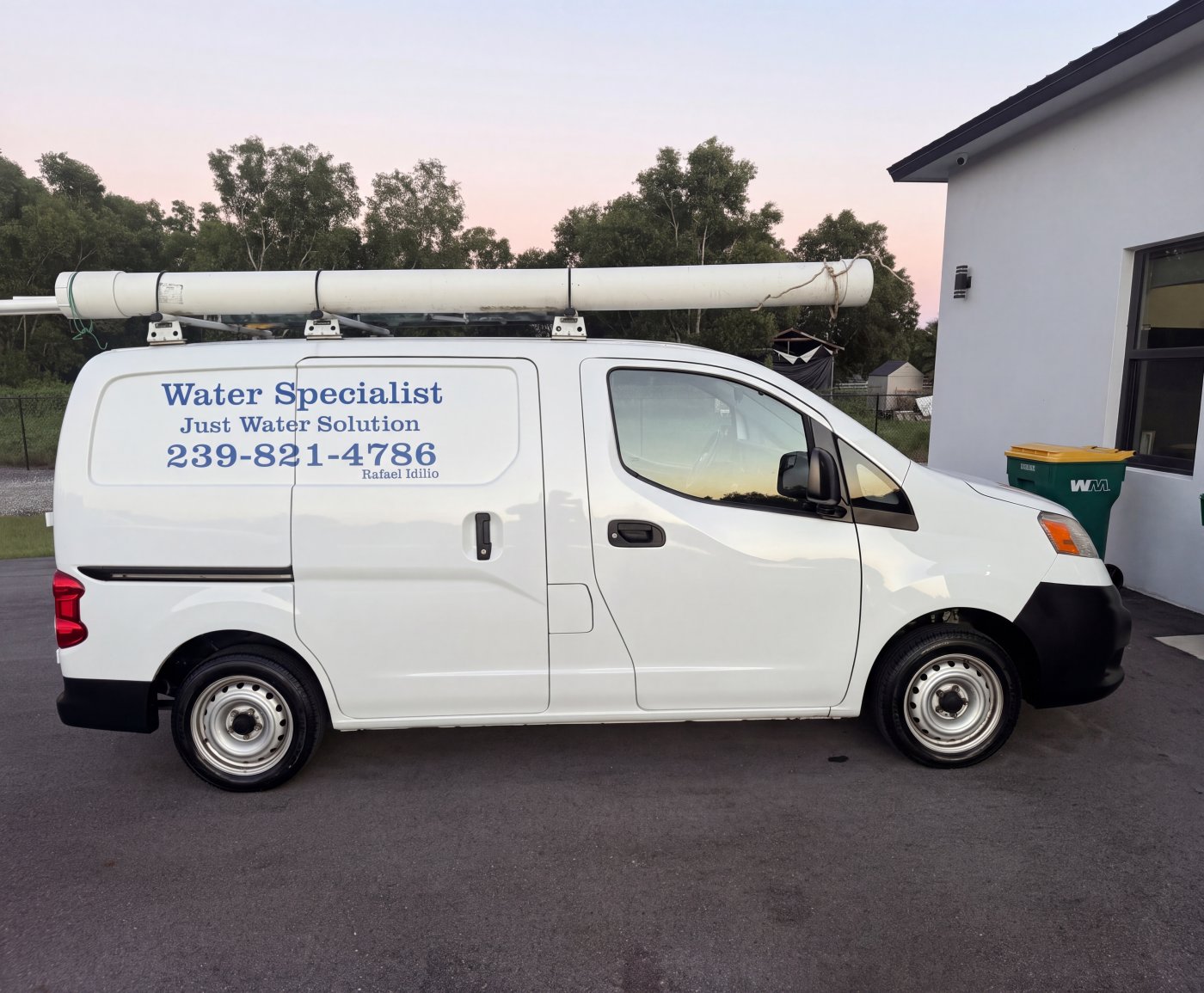 Just Water Solution white service van with the company name and phone number on the side