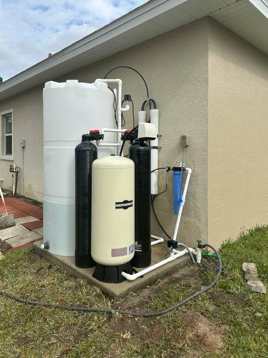 Water treatment system tucked into the corner of a home