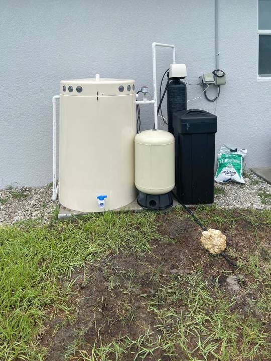 Softener with brine tank beside a storage tank