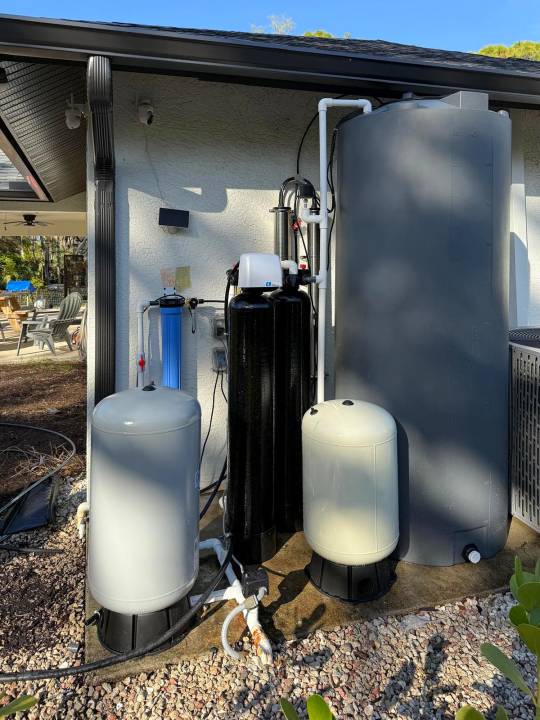 Stainless membrane housings and filter tanks next to a covered patio