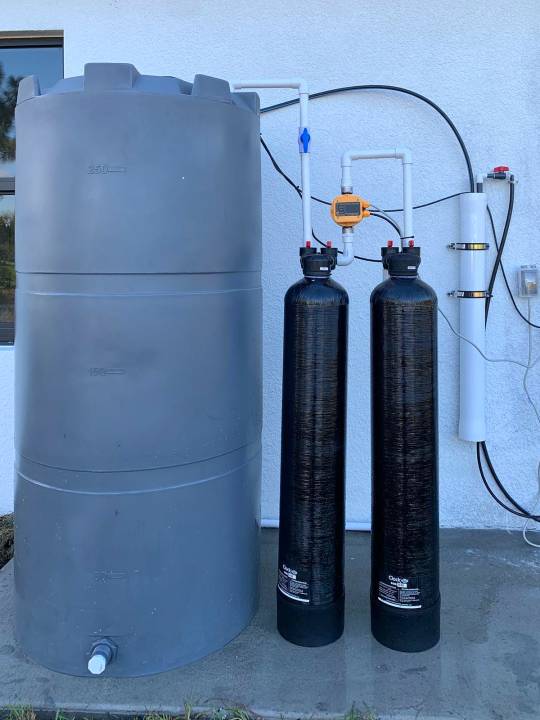 Twin filter tanks with a gray storage tank