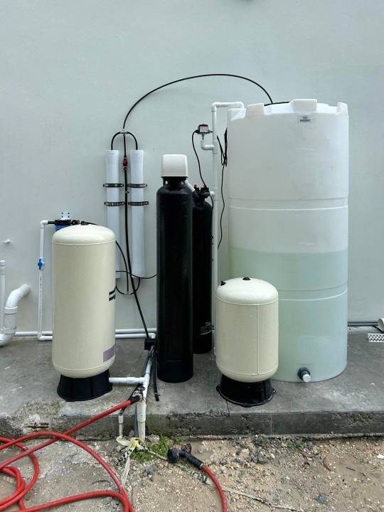 Whole-house system with a white storage tank and 2 membrane housings
